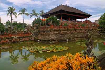 Scenic view of lake by building against sky