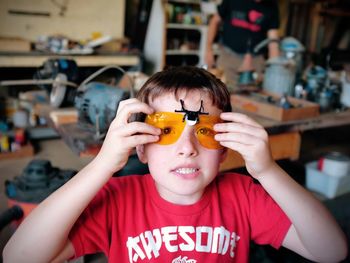 Portrait of boy wearing protective eyewear at garage