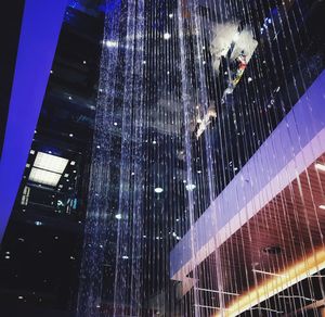 Low angle view of illuminated buildings at night