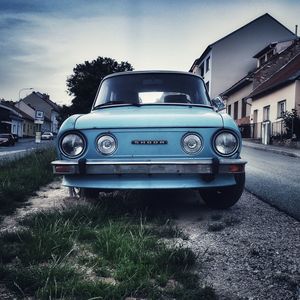 Vintage car on building in city against sky