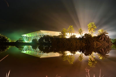 Reflection of trees in water at night