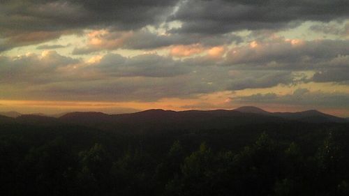 Scenic view of mountains against cloudy sky