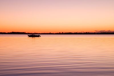 The first light of day creates dramatic colors in the sky over the sea