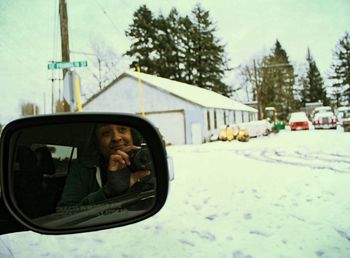 Portrait of man photographing in car