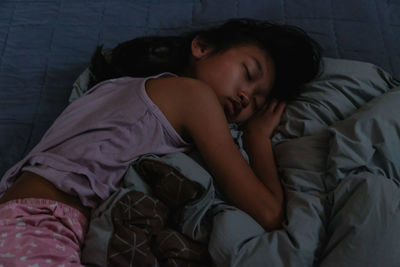 Young woman sleeping on bed