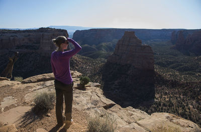 A woman overlooks colorado national monument in colorado.