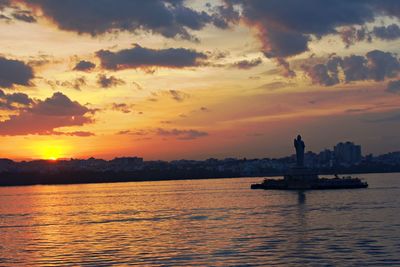 Silhouette boat in sea against sky during sunset