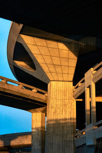 Low angle view of illuminated bridge against sky