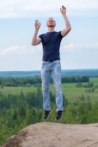 Full length of man standing on landscape against sky