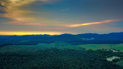 Scenic view of field against sky during sunset