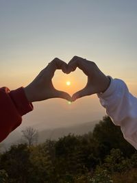 Low section of man holding hands