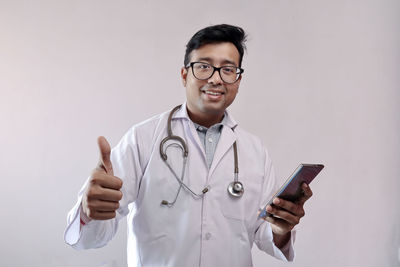 Portrait of smiling young man using smart phone