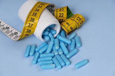 High angle view of pills on white background