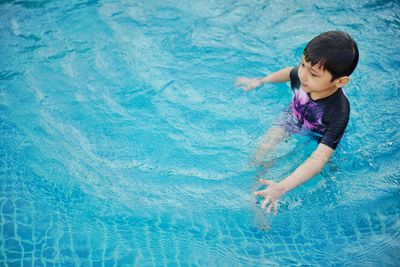 Boy swimming in pool