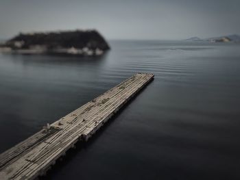Close-up of pier on sea against sky