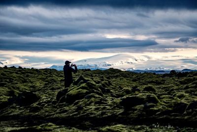 Man standing on mountain against sky