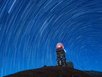 Low angle view of light painting against sky at night