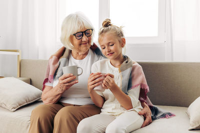 Young woman using mobile phone at home