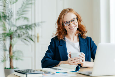 Portrait of businesswoman working at desk in office