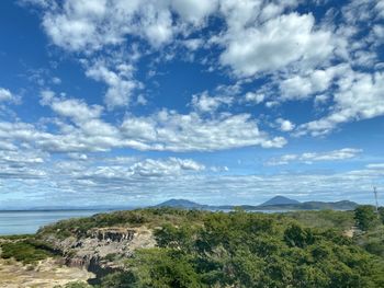 Scenic view of sea and mountains against sky