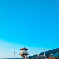 Low angle view of house against clear blue sky