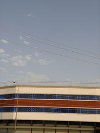 Low angle view of train against buildings against sky