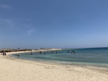 Scenic view of beach against blue sky