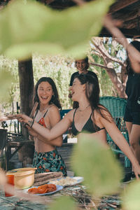 Portrait of smiling friends sitting at restaurant