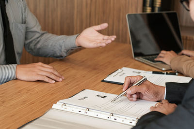 Midsection of people on table