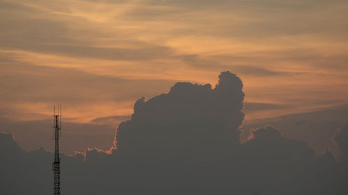 Silhouette mountains against orange sky