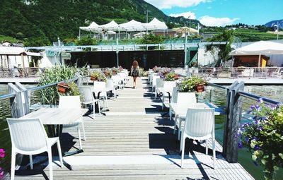 Chairs and tables in restaurant against building