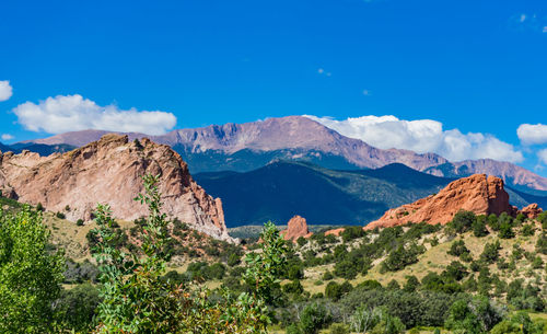 Scenic view of mountains against blue sky