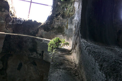 Close-up of rock against sky seen through window