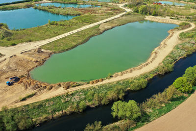 Aerial view of an active gravel pond beside the river leine near sarstedt, germany, with a truck