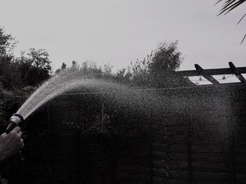 Low angle view of hand against clear sky