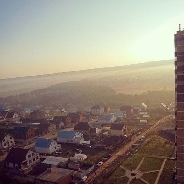 building exterior, architecture, built structure, high angle view, landscape, clear sky, cityscape, copy space, city, sunset, residential district, house, residential structure, sky, residential building, scenics, horizon over land, town, nature, aerial view