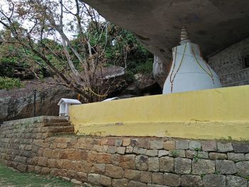 Stone wall by old building