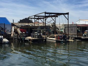 Boats moored in river against buildings in city