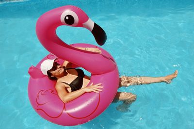 High angle view of woman floating in swimming pool