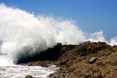 Waves breaking against sea