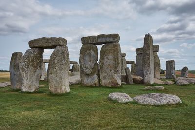 Stone structure on field against sky