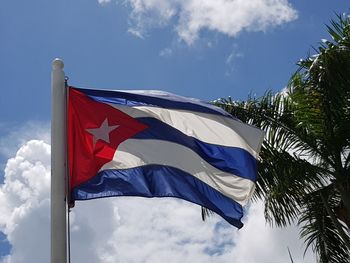 Low angle view of flag against blue sky