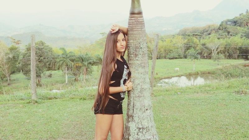 young adult, young women, lifestyles, standing, person, grass, long hair, casual clothing, leisure activity, tree, sensuality, beauty, three quarter length, front view, field, looking at camera