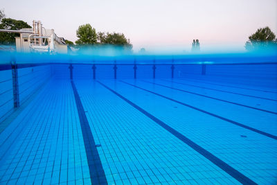 Swimming pool against clear blue sky