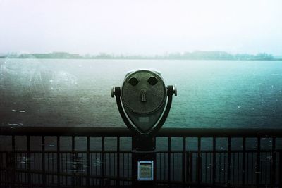 Close-up of railing against sea