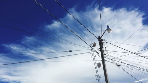 Low angle view of power lines against sky