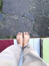 Low section of man standing on footpath