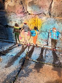 People walking on graffiti wall