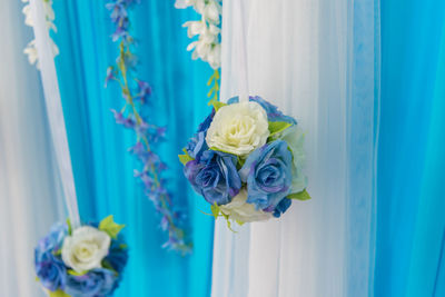 Close-up of rose bouquet against blue water