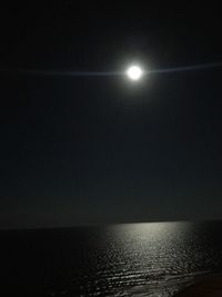 Scenic view of sea against clear sky at night